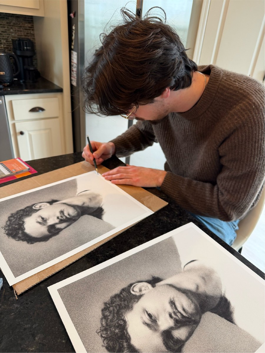 Frank signing prints
